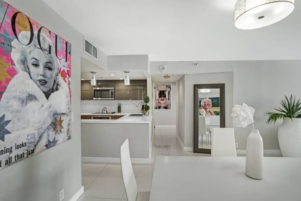 Dining area, fully equipped kitchen with washer/dryer, view into master bedroom 