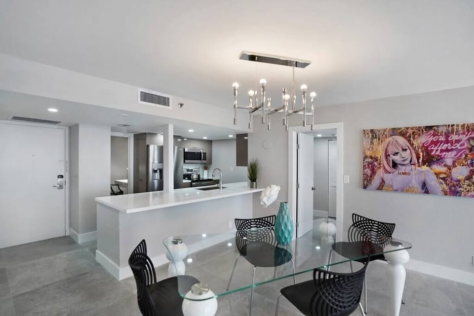 Dining area, unit entrance, fully equipped kitchen, door to master bedroom suite