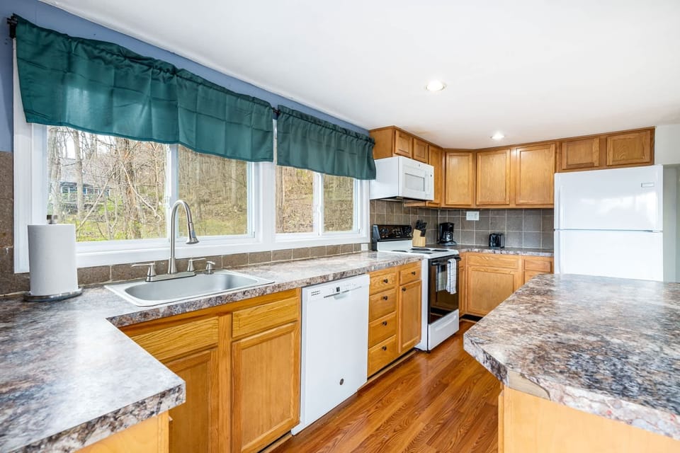 Fully-stocked kitchen with a dishwasher, stove/oven, and microwave