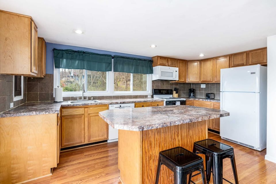 Fully-stocked kitchen with a dishwasher, stove/oven, and microwave