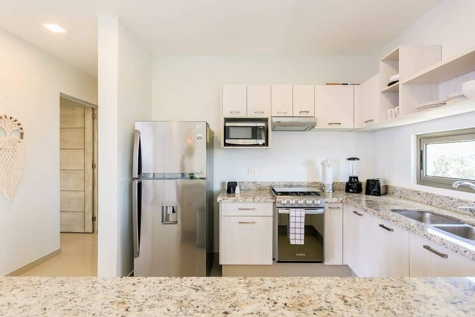 Granite countertops in the kitchen that's fully-equipped with all new appliances
