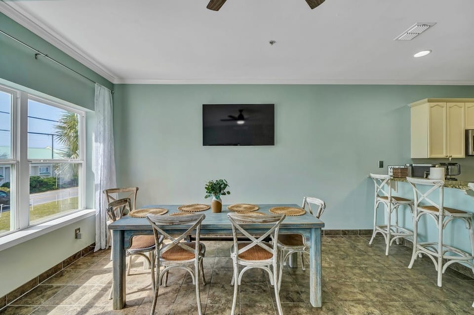 Dining room table seats 8 comfortably, with 4 more at the bar