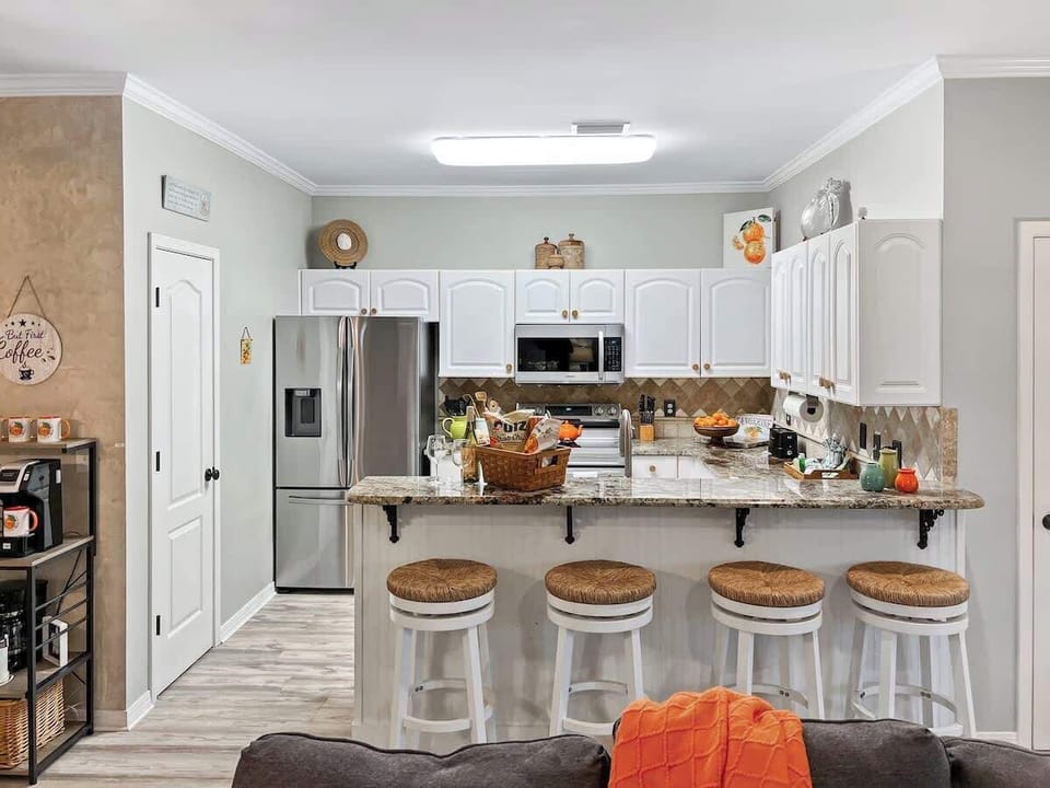 The open-plan kitchen is fully stocked and can seat 4...