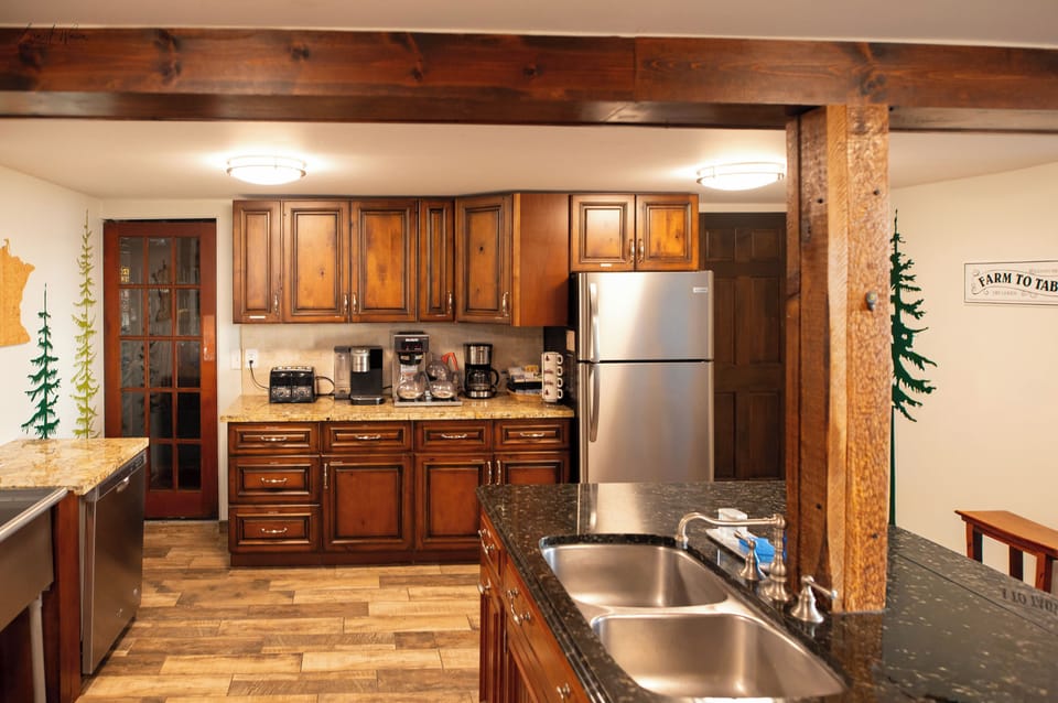 Kitchen has 2 full size sinks 1 on left of picture is commercial sink