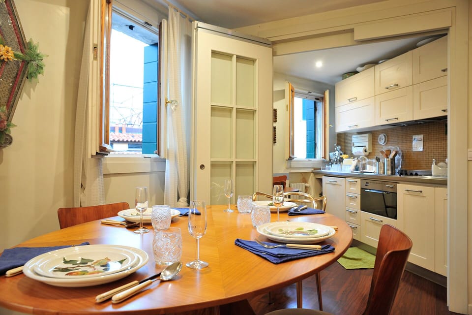 The dining room is lit by recessed lighting.