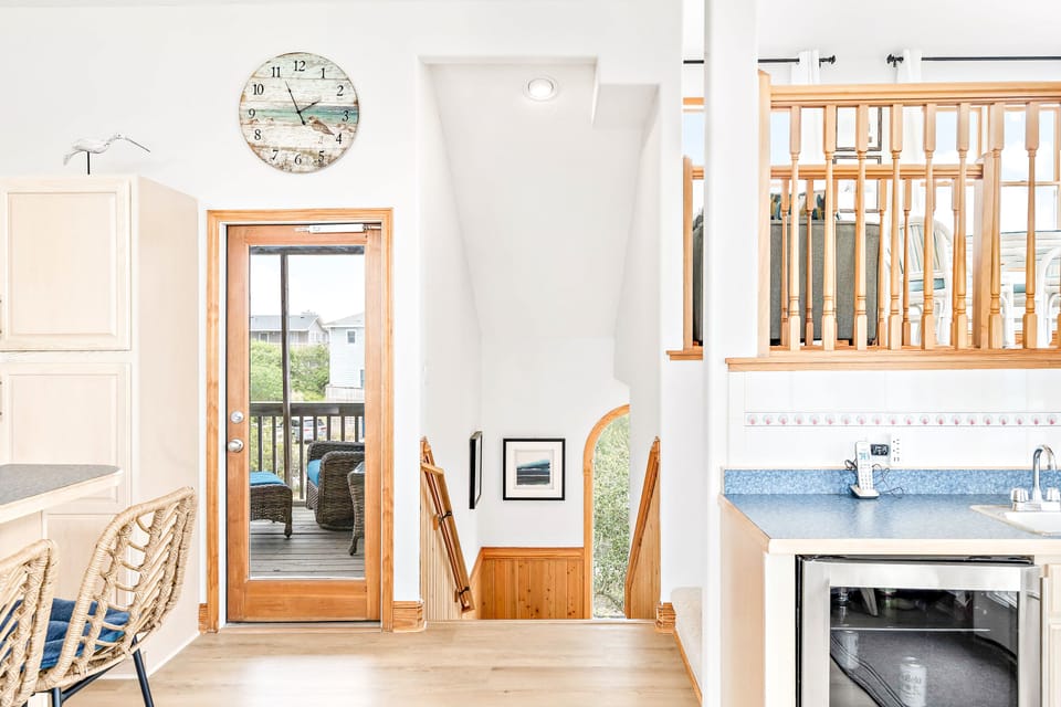 view walking up stairs to bar, captain's loft and screened porch off kitchen