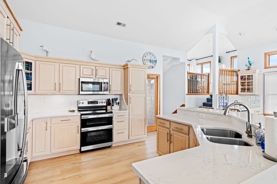 Updated spacious kitchen with new quartz counters, double oven and air fryer.