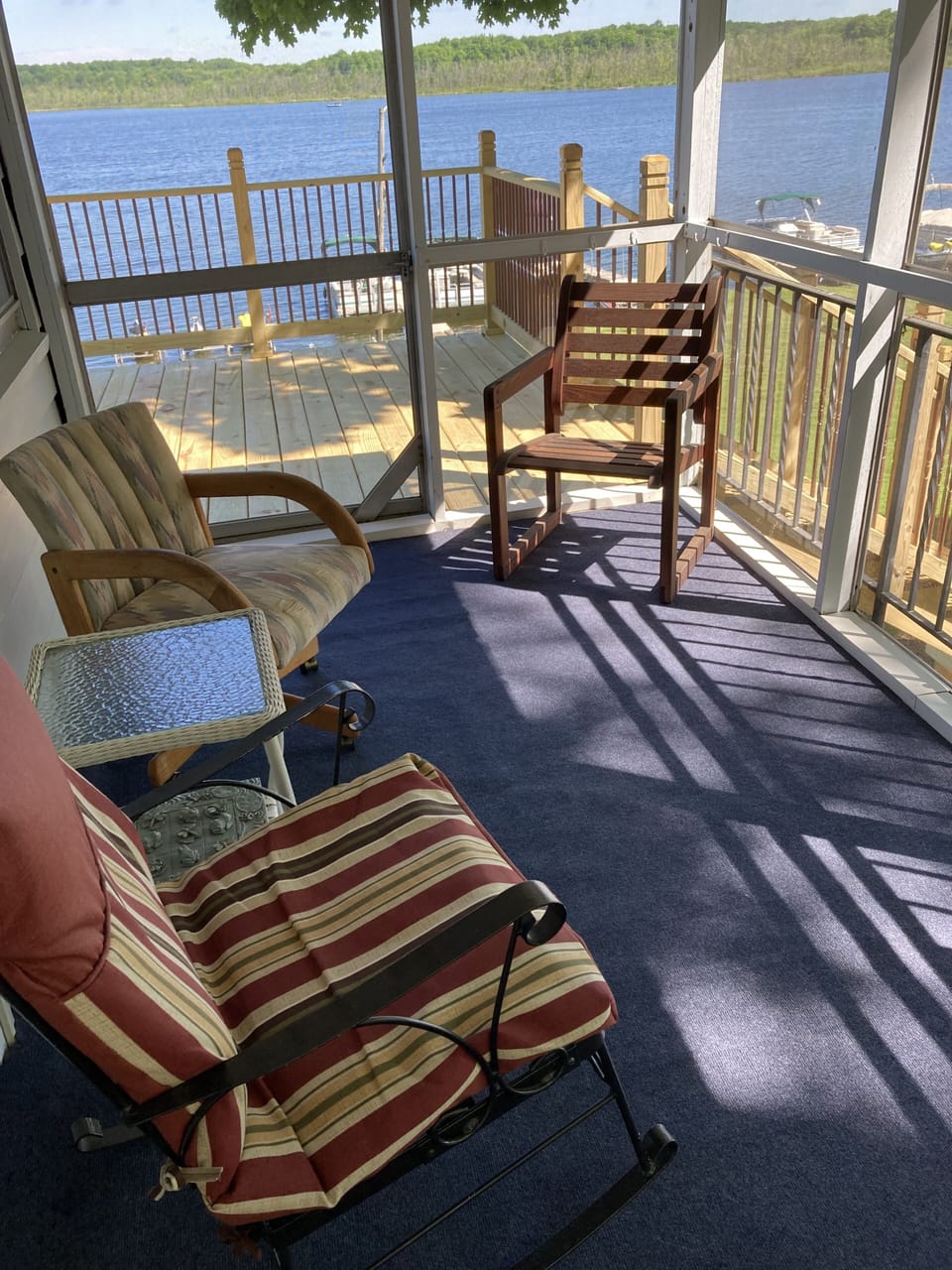 This three-sided screened-in porch off the kitchen is a joy to relax in.