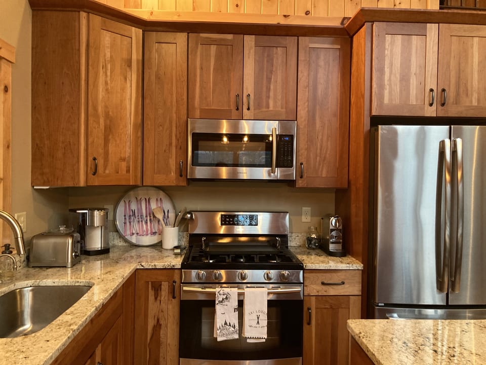 Updated and fully stocked kitchen for preparing family meals. 