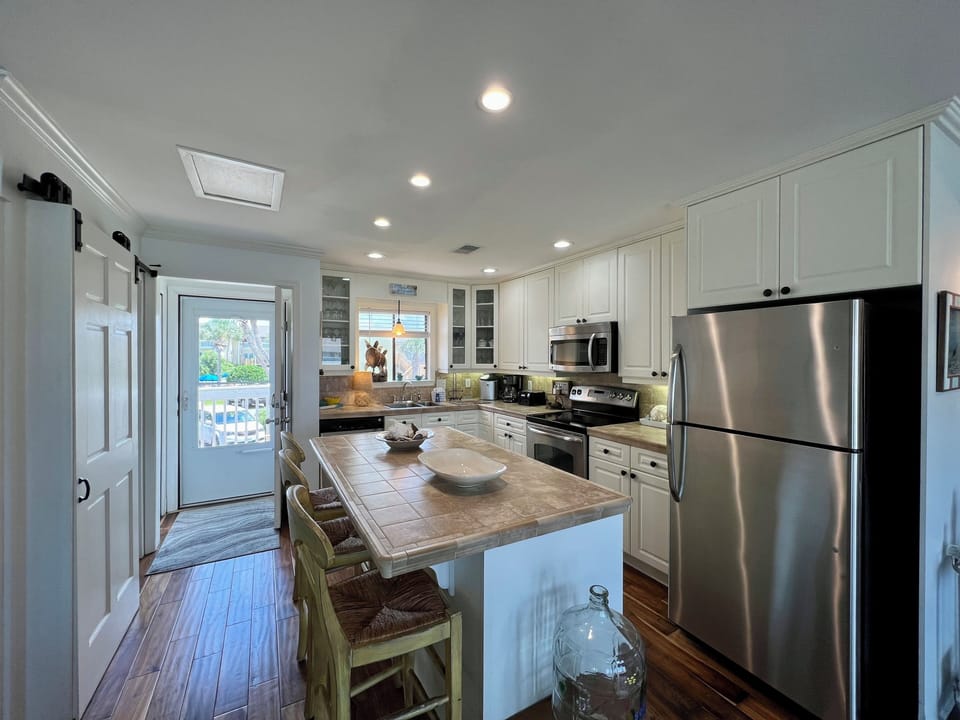 Your fully equipped kitchen features stainless steel appliances, granite counters, and island seating perfect for morning coffee or meal prep.