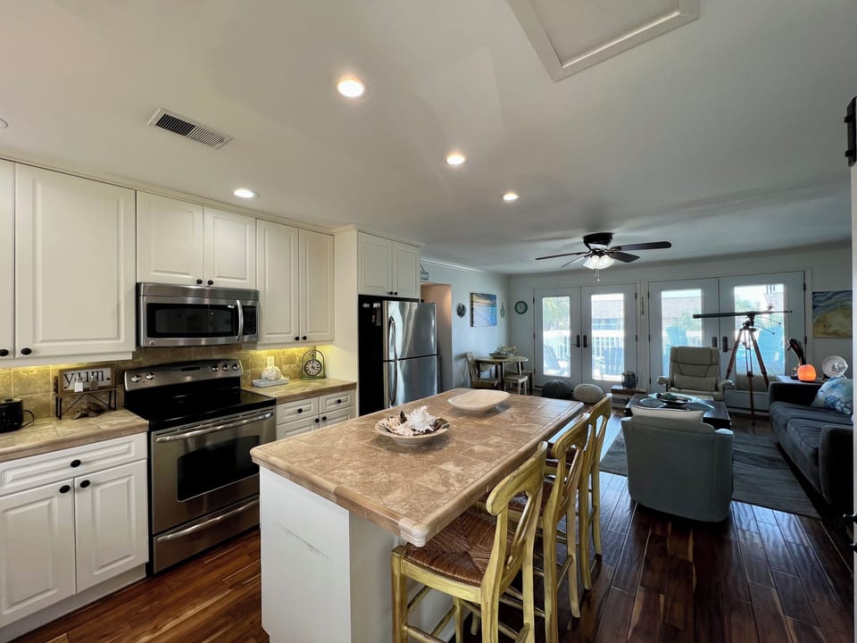 Your spacious kitchen flows seamlessly into the living area, with granite counters and stainless appliances for memorable meals together.