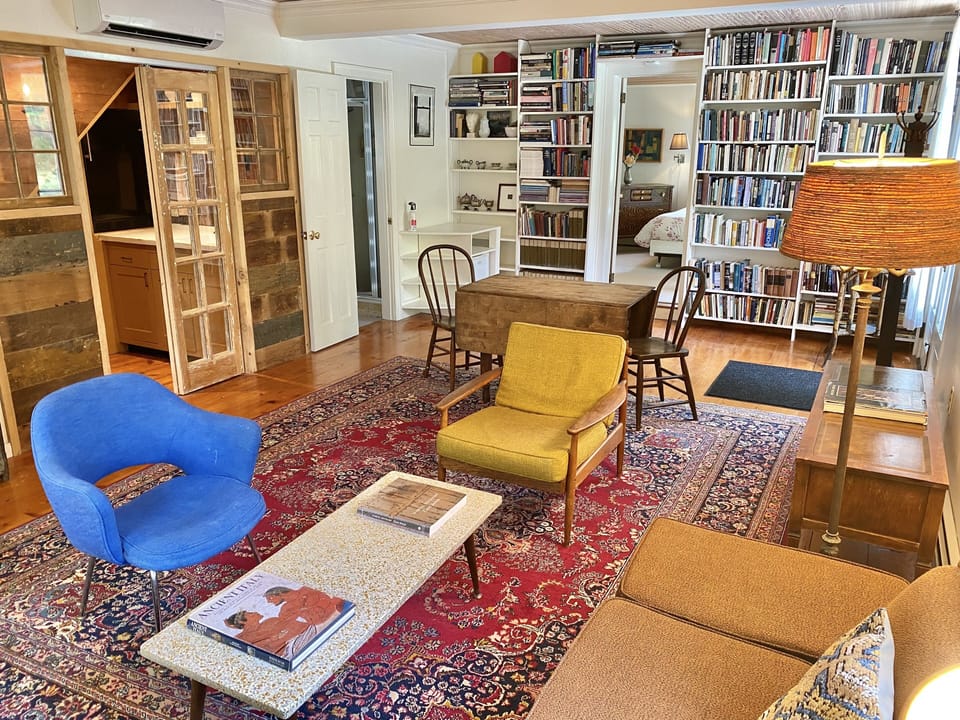 Mid-century furniture, books galore, and a quaint farmhouse kitchenette.