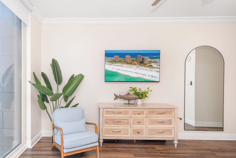 You'll love this bright, airy space with coastal artwork and natural light streaming through large windows, creating your perfect retreat.