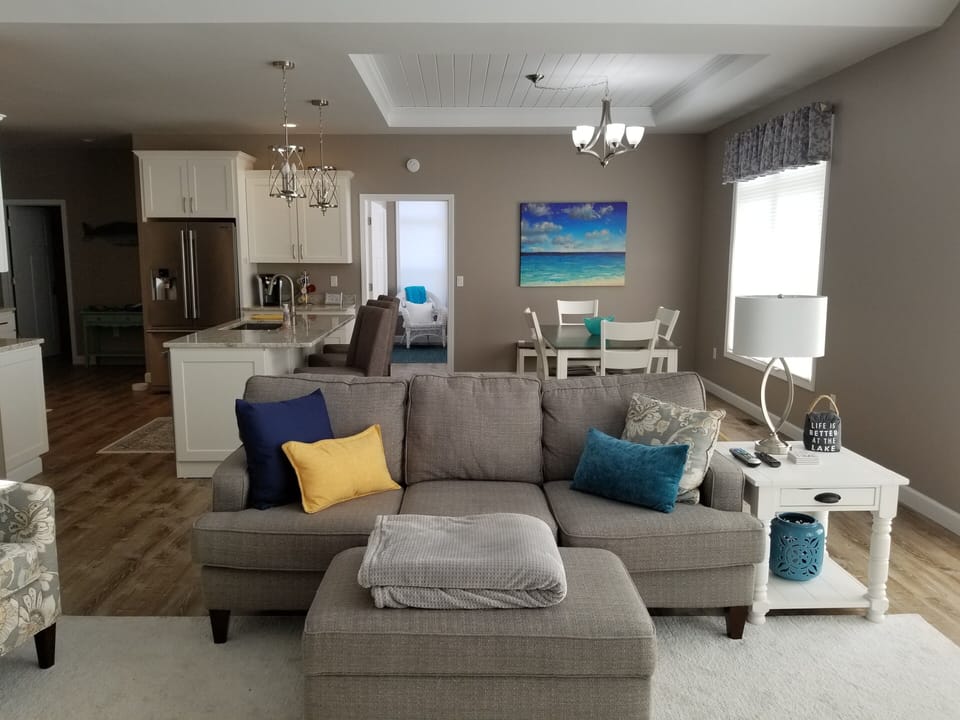 Comfortable couch between living room & kitchen