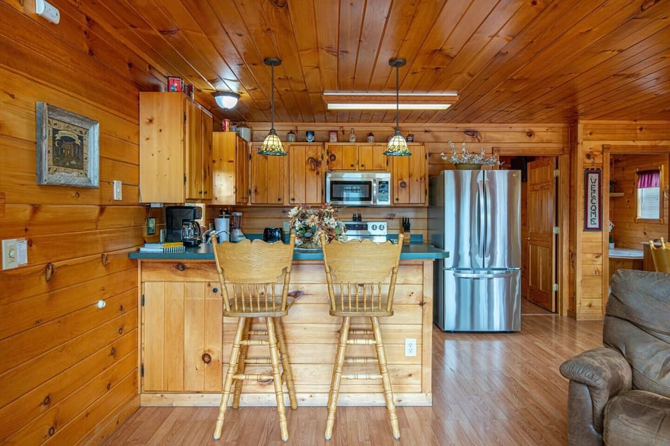 Kitchen with stainless steel fridge, dishwasher and oven.