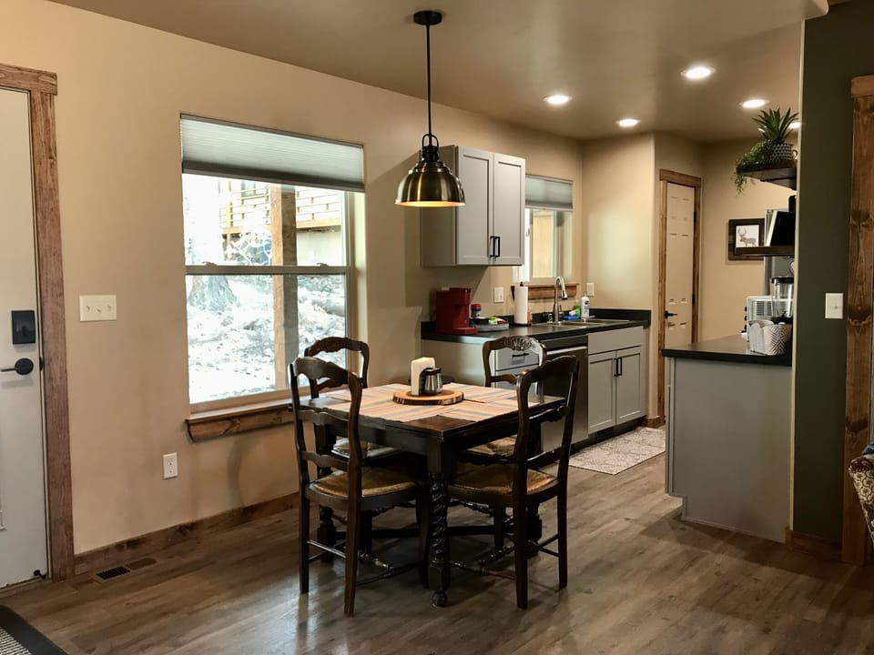 Dining area with antique drop leaf table. Leaves slip out manually.