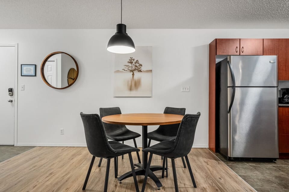 Dining area with seating for 4 at the table, and 2 on the island.
