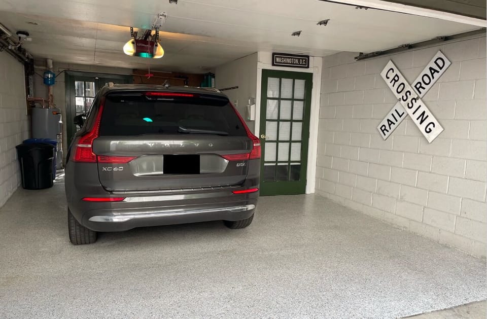 The green door to the right of the vehicle is the entrance to the studio.