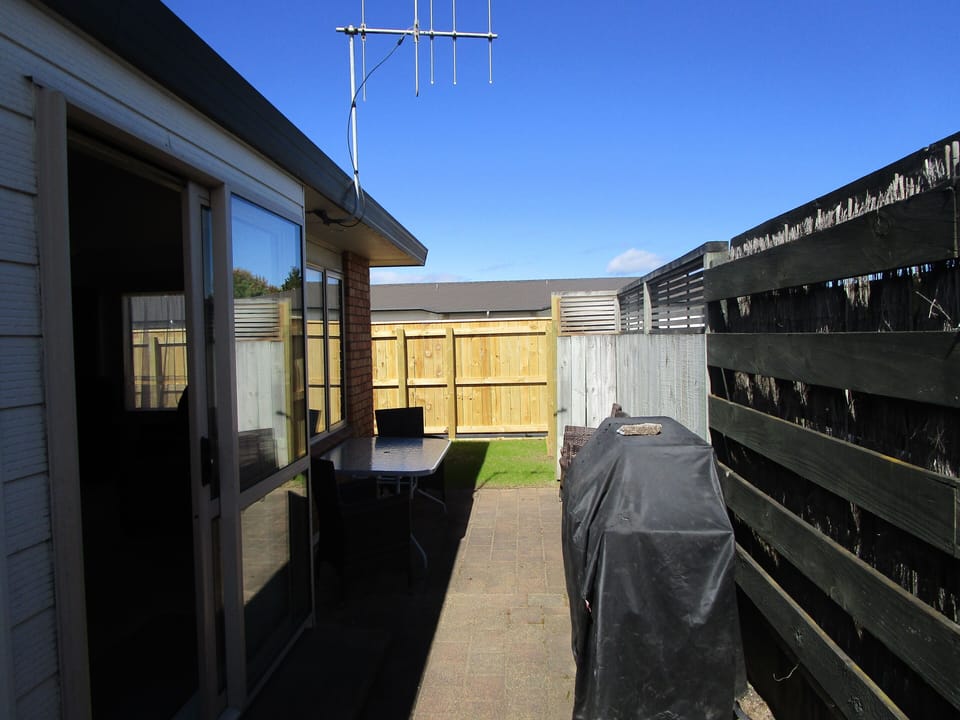 BBQ and outdoor table for guests to enjoy.