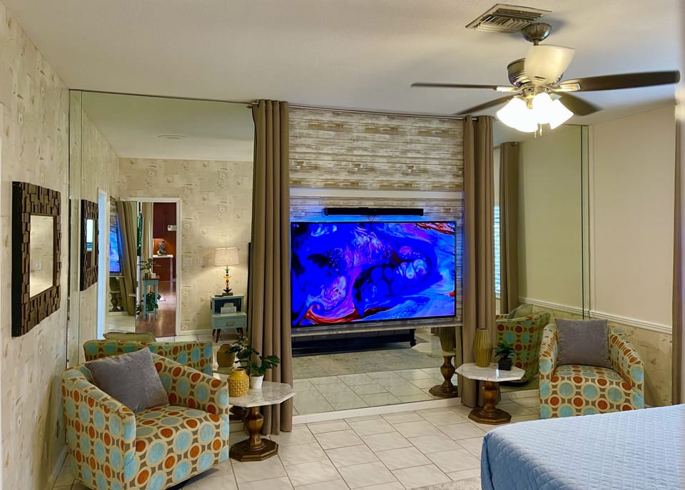 Master Bedroom includes seating area and a 75” SmartTV… movie night in bed!