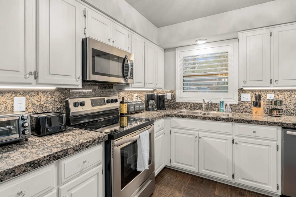 Fully equipped kitchen, including toaster, toaster oven, spice rack, olive oil, knife block.