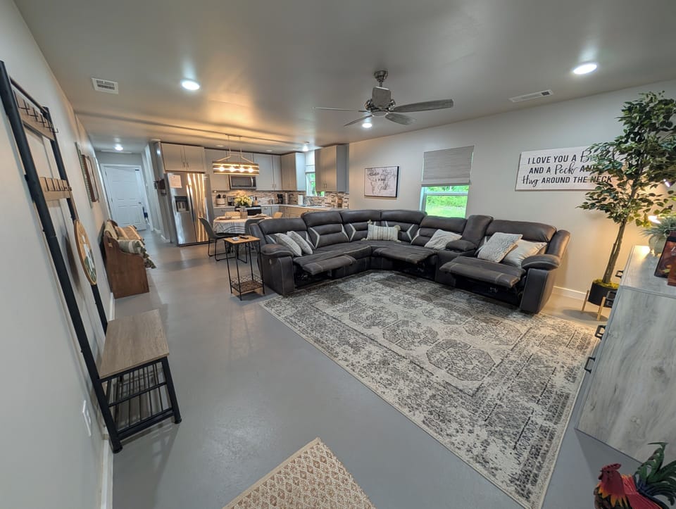 The living room sofa has 3 motorized recliners; sit back and enjoy movie night.