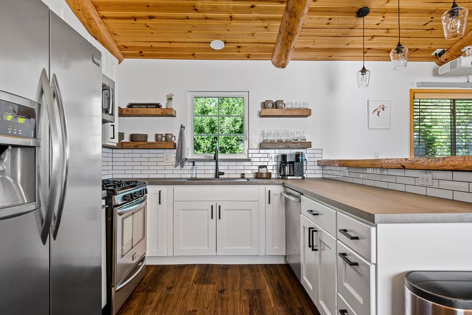 Fully renovated kitchen has plenty of counter space plus a breakfast bar.