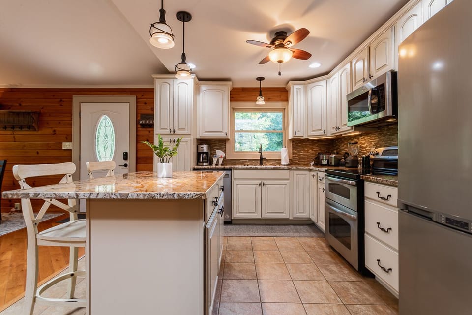 Kitchen w/ electric smooth top range & double ovens
