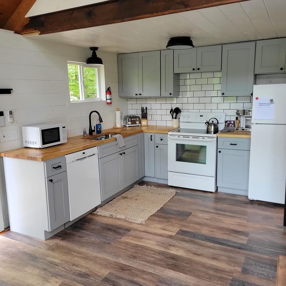 The cozy kitchen is fully equipped for all your cooking needs during your stay