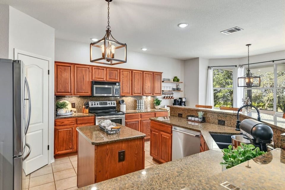 Bright and open, the kitchen overlooks the backyard—perfect for gathering, meal prep, and connecting with family and friends.