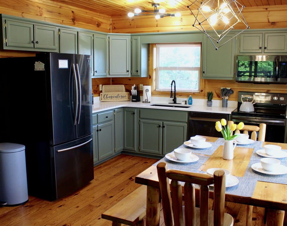 Newly painted cabinets and new quartz countertops complete the luxury experience in the stocked kitchen.