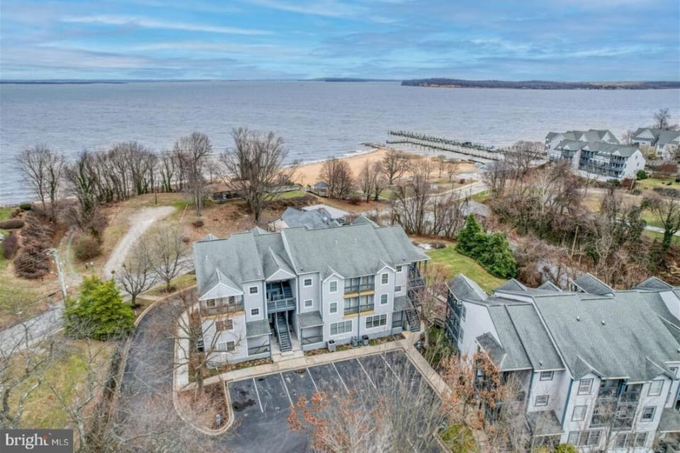 Aerial view of condo, beach and bay.