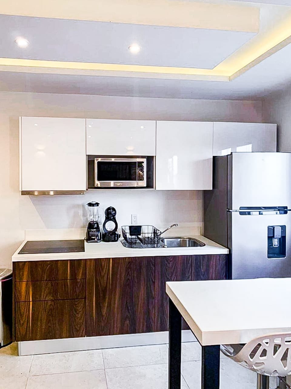 Modern kitchen with white refrigerator, fully equipped for your culinary needs
