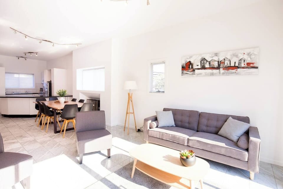 Unwind in the spacious living room, complete with three comfortable couches and a smart TV for your evening entertainment.