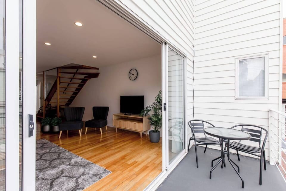 Outdoor seating on the balcony provides the perfect place to unwind with a glass of local Tasmanian wine. 