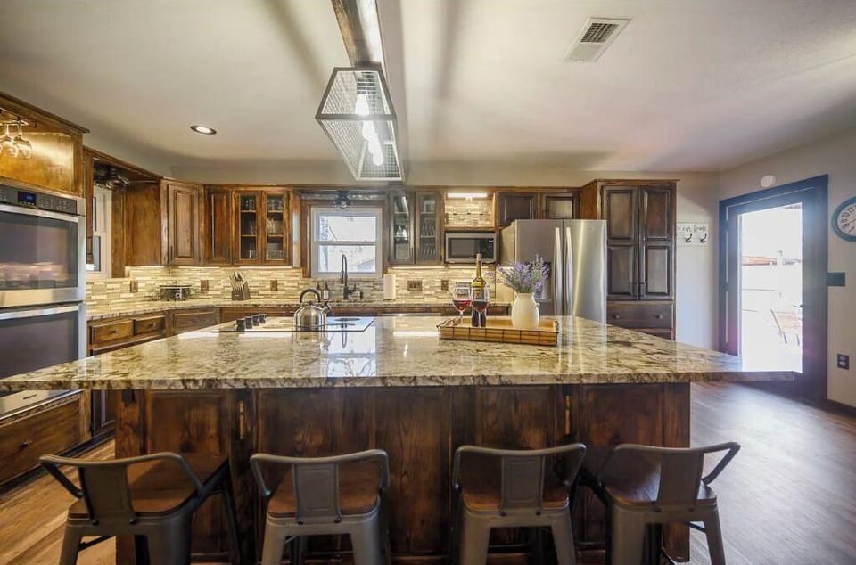 Kitchen Features Giant Island Cooktop w/ Additional Seating, and Double Oven