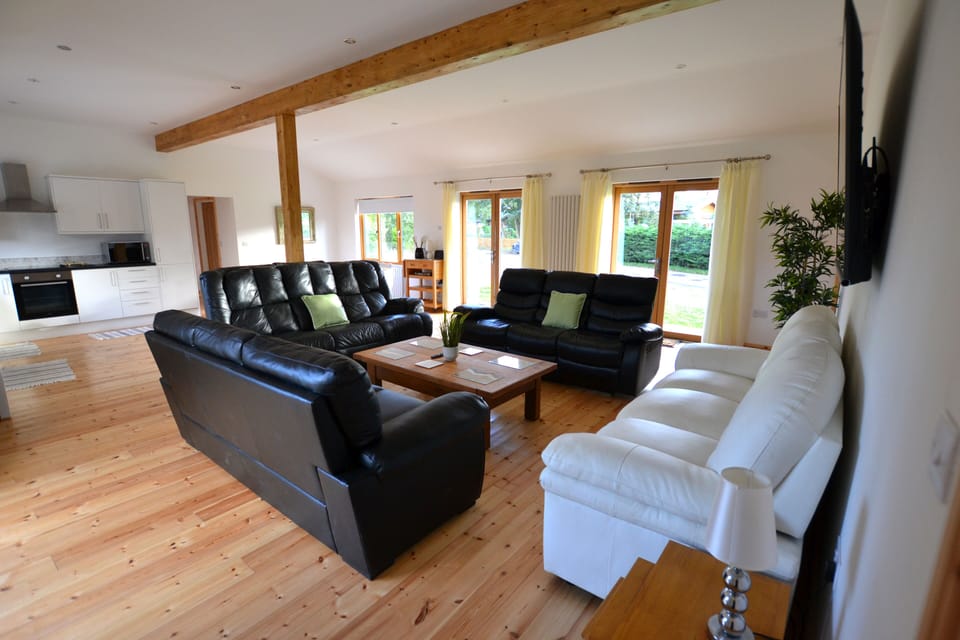 living area with 4 x3 seater, cumfy setees, 2 of which are reclining