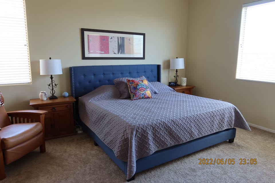 Primary bedroom with king bed and recliner for reading-Door to patio is to right