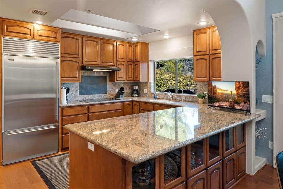 The custom wood kitchen is modern and fully-equipped