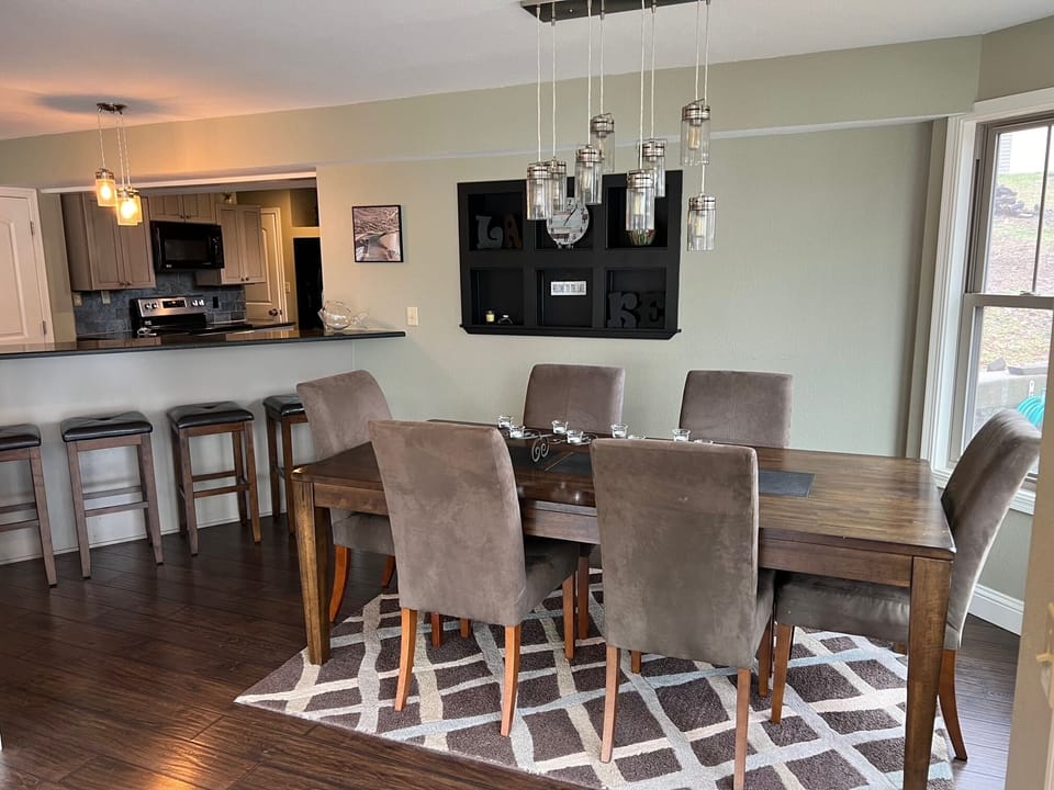 Large dining table and bar stool seating. 