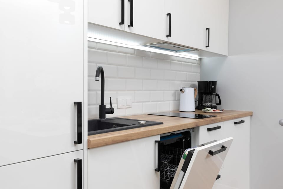 Kitchenette with dishwasher and refrigerator. 