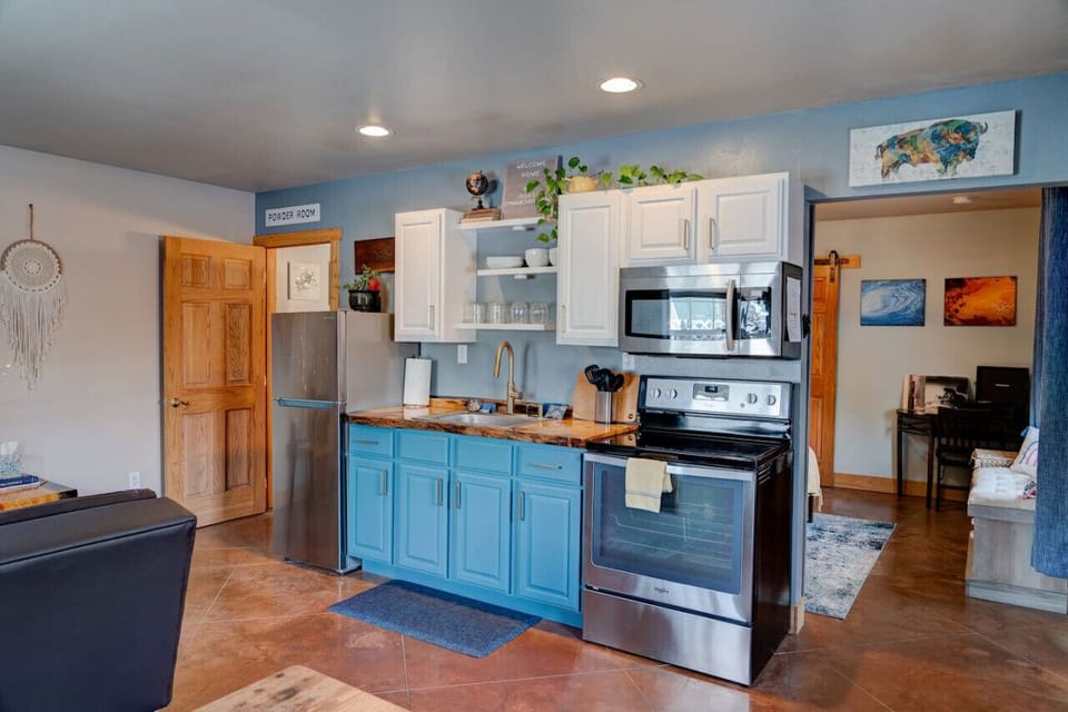 Kitchen with handmade countertop. Assorted spices and oils are provided, as well as all basic cooking necessities: pots, pans, utensils, measuring cups and spoons, knives, cutting boards, cheese grater, toaster, etc