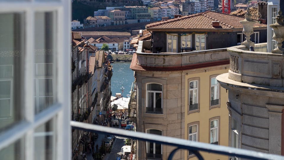 Step out onto your private balcony and immerse yourself in the vibrant city atmosphere, watching daily life unfold with stunning views of historic architecture and the serene river beyond. This panoramic outlook offers an authentic glimpse into the city's