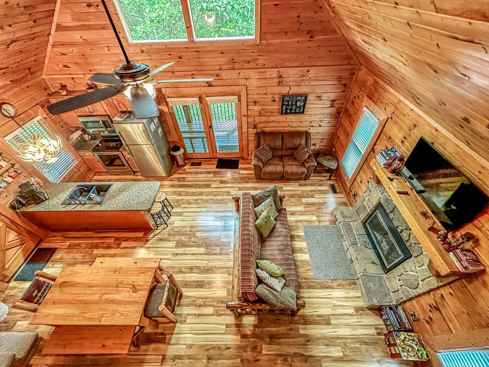 Living area view. 46" TV, firewood fireplace, couch and full size sleeping futon