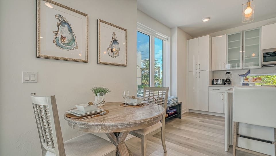 A bistro table for two sits near the window—a cozy nook for coffee, games, or planning tomorrow's adventure.