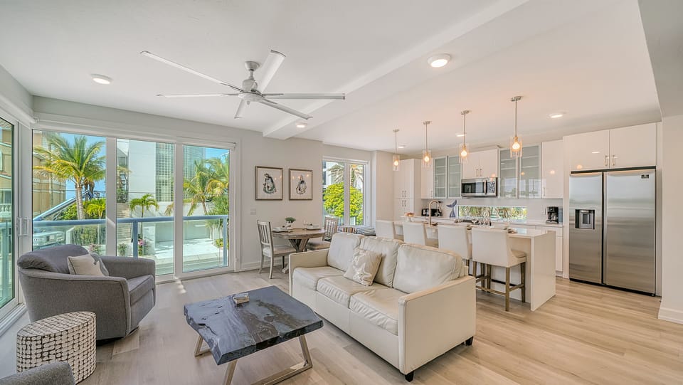 Kitchen, living room and breakfast bar. Thoughtfully laid out living room. The kitchen breakfast bar with seating for four. Expansive windows with great natural light and wonderful views.