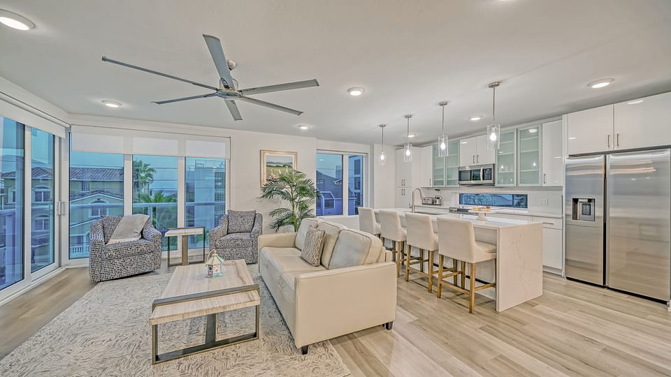 The top floor - the main living area. Living room, breakfast bar, dining area, and kitchen with outdoor views.