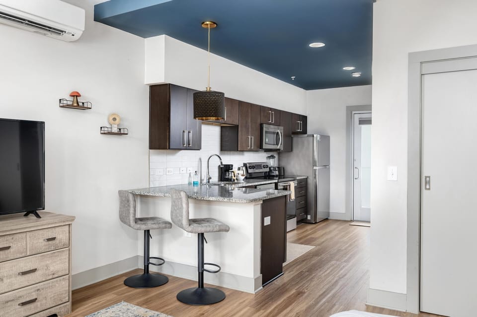 Modern kitchen with sleek island seating and stainless appliances