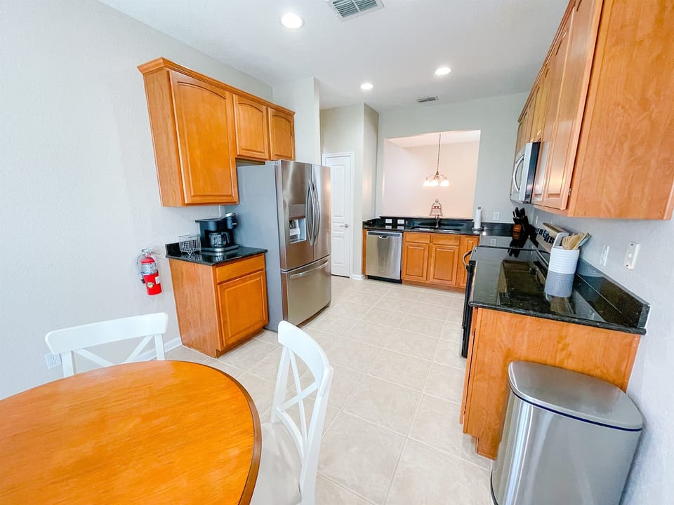 Spacious kitchen stocked with all the dishes, utensils, pots and pans you'll need - plus table and seating for four.