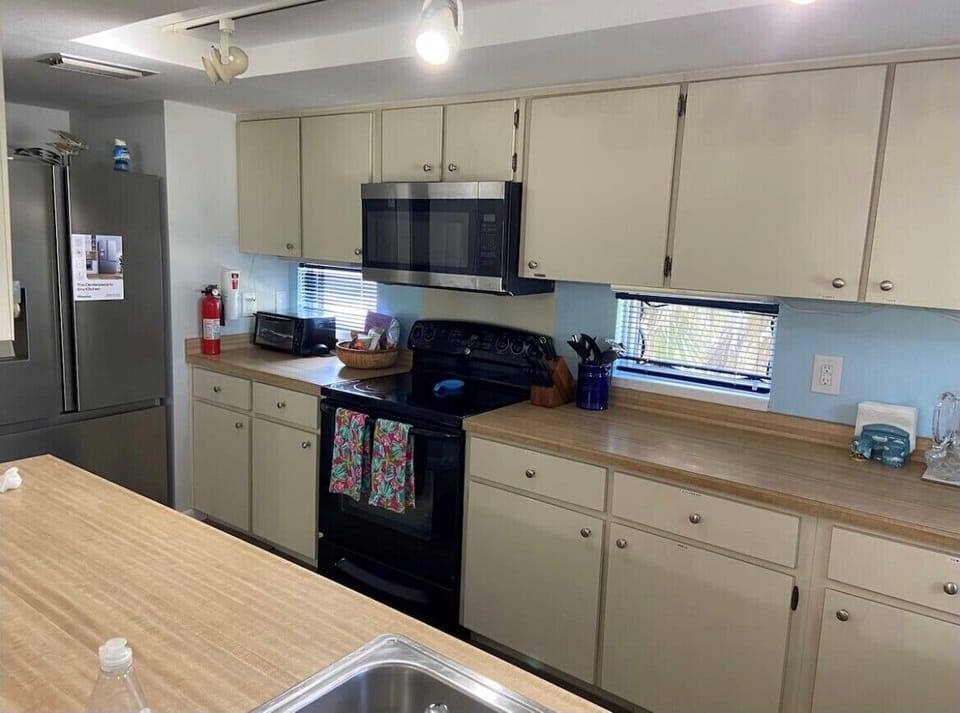 Additional view of kitchen with new stainless steel fridge - ice maker!